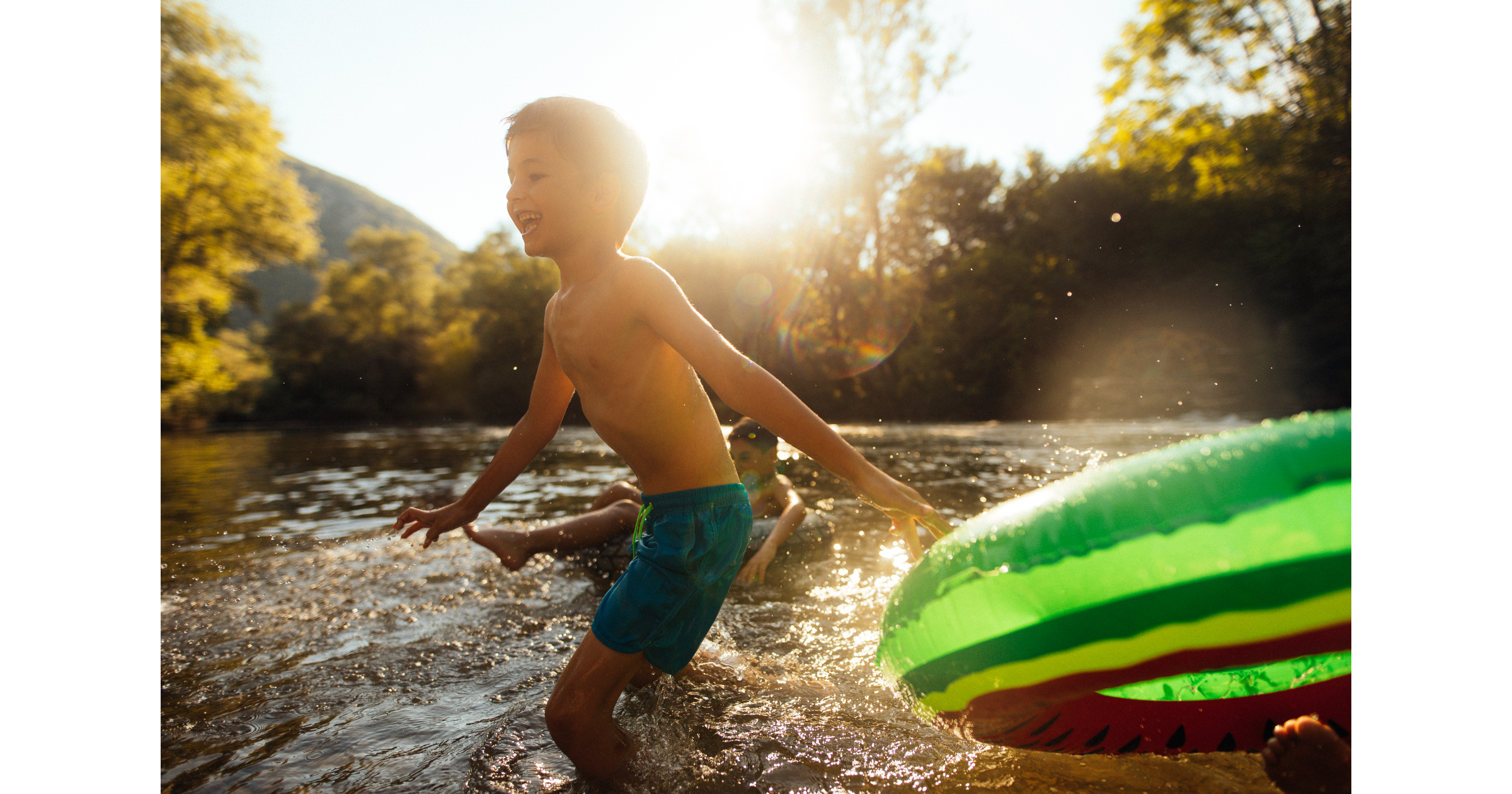 Two boys playing in the river on a nice sunny day.