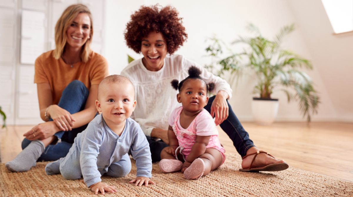 Two Denver moms watch their babies crawl. They are happy to be part of a wonderful ABC nanny share.