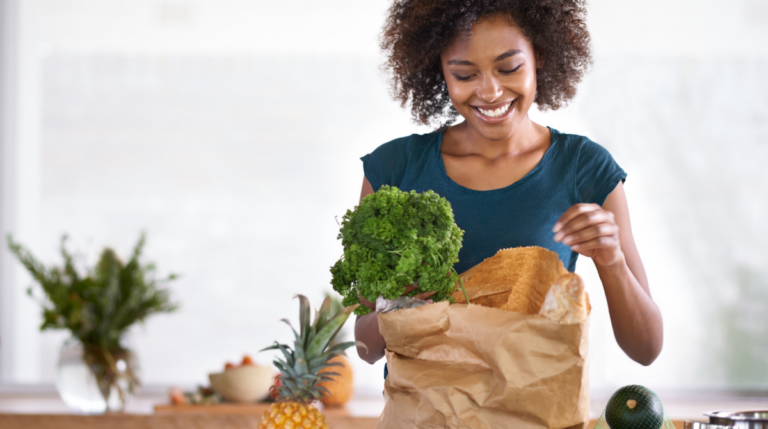 A family assistant unpacking groceries on a kitchen counter