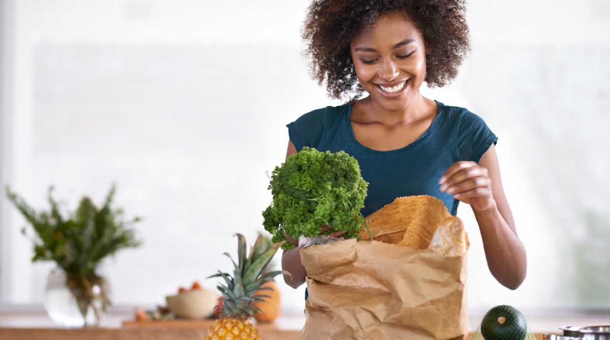 A family assistant unpacking groceries on a kitchen counter